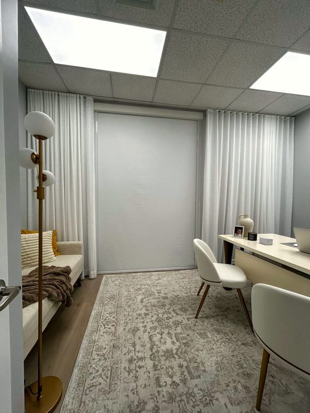 Private office. Sheers on both walls and a roller shade at the end, so the screen stays readable at every hour without closing the room.